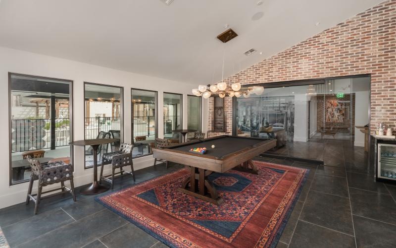 billiards room with tables and chairs