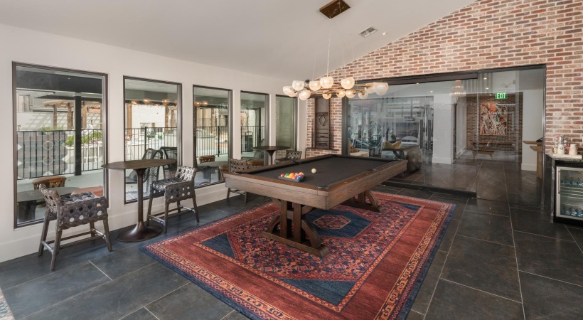 billiards room with tables and chairs